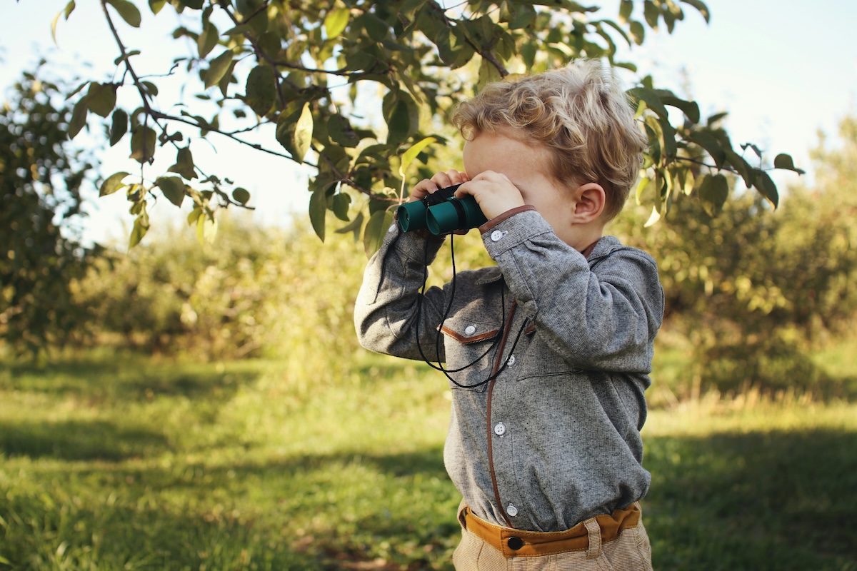 Boy looking through binoculars